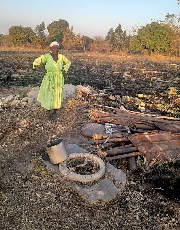 Picture of woman next to her metal scrap