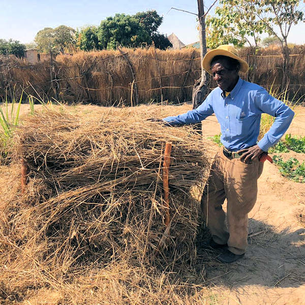 Man next to compost pile