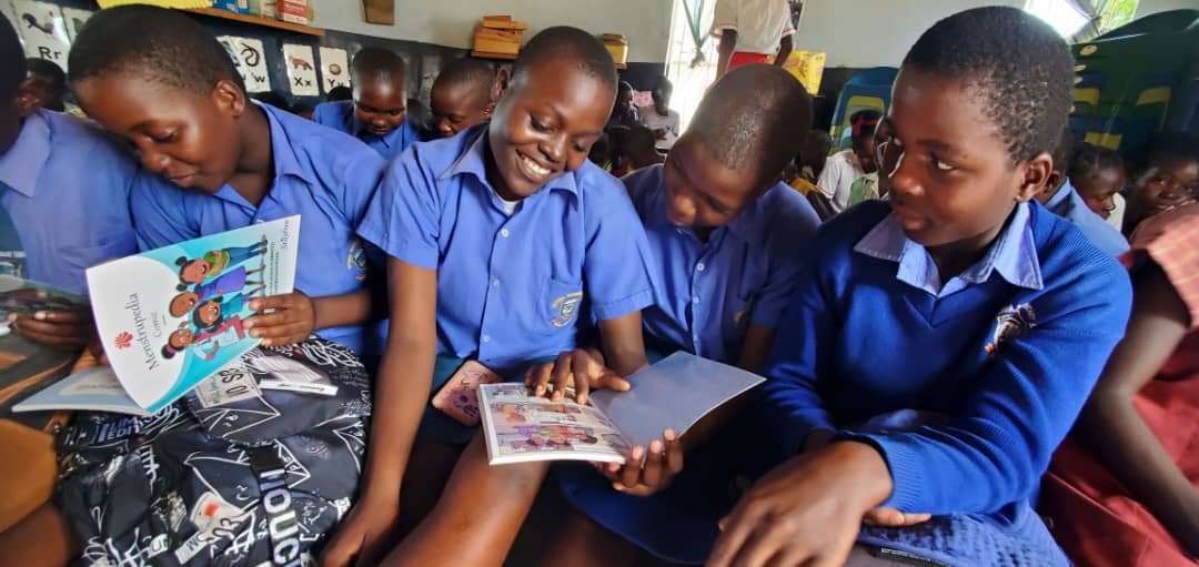 four girls close up with book