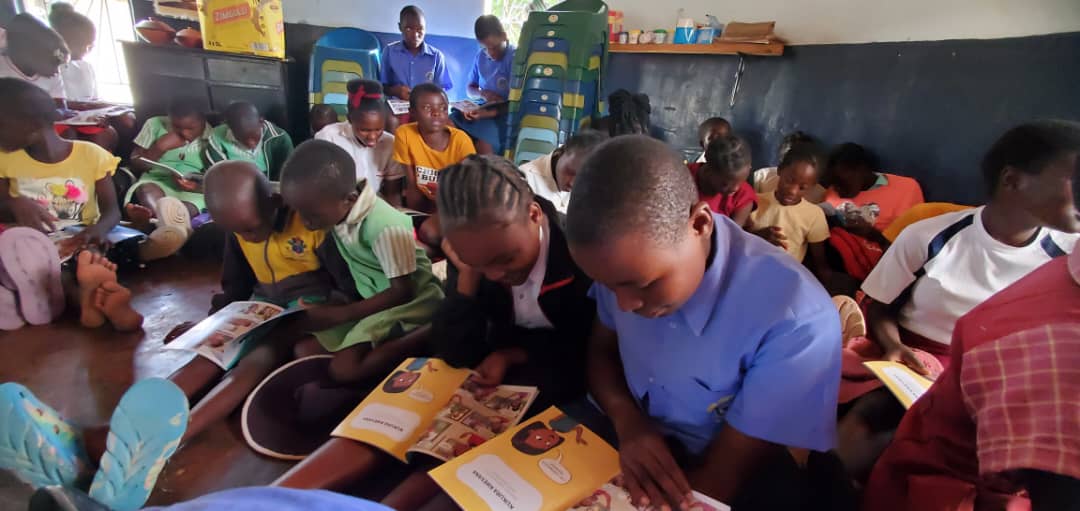 line of girls studying the book