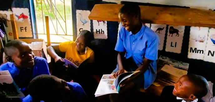 three girls close up with book