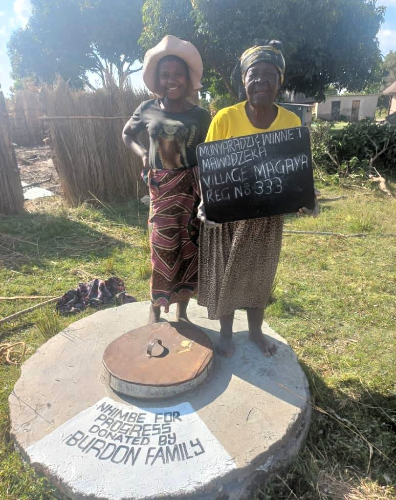 Persons standing next to well