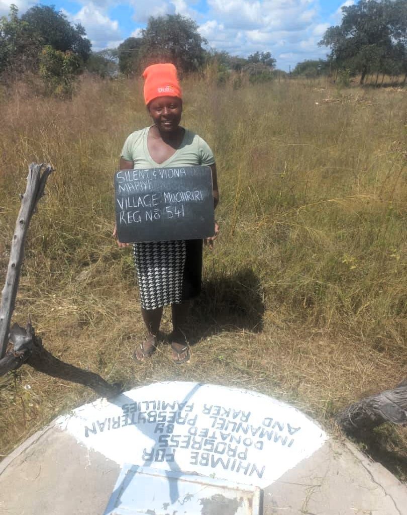Person standing next to well