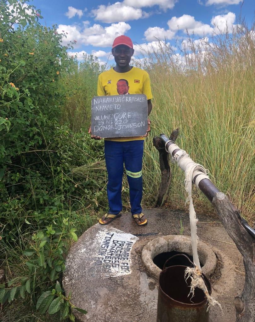 Person standing next to well