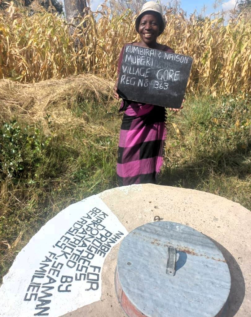Person standing next to well
