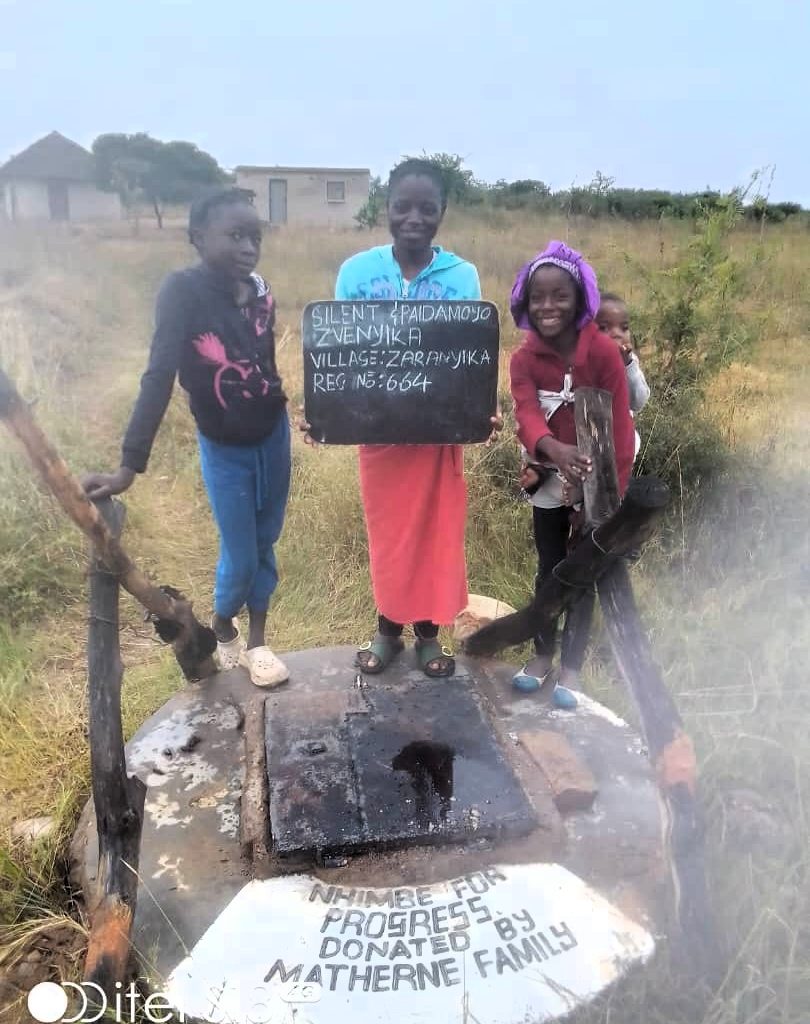 Children standing next to well