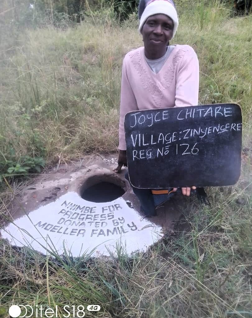 Person standing next to well