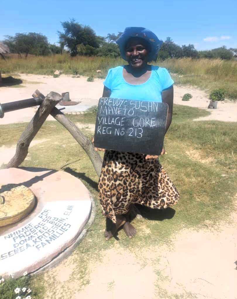 Person standing next to well