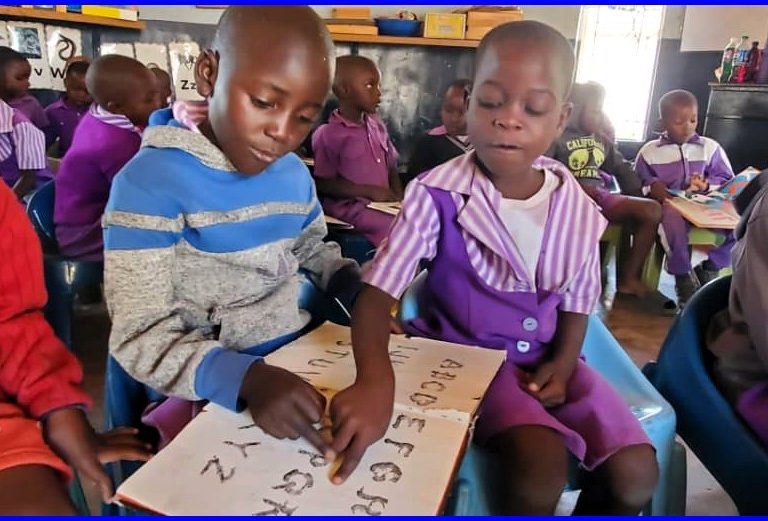 girl pointing at alphabet